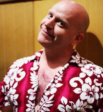 BiCon attendee smiling, wearing a Hawaiian shirt