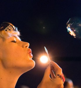 Person blowing bubbles at night at BiCon bisexuality convention